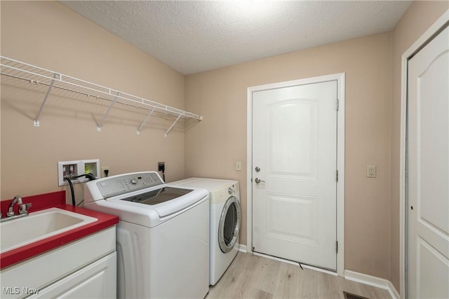 453 Bridge Pointe Ln, Brunswick, OH 44212 - laundry area with light wood finished floors, washer and clothes dryer, and baseboards