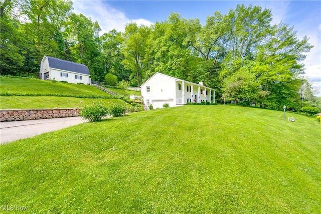 514 Michael Ln, Zoar, OH 44697 - view of grassy yard featuring a garage and view of scattered trees