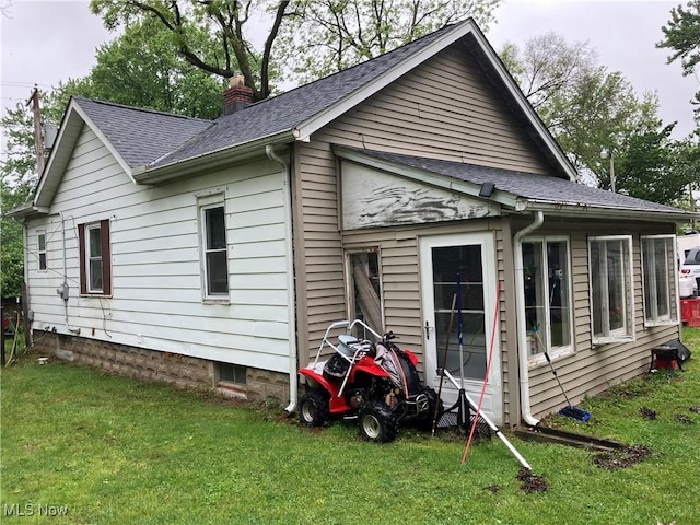 1293 W Jackson St, Painesville, OH 44077 - view of side of home with a chimney, a lawn, and a shingled roof