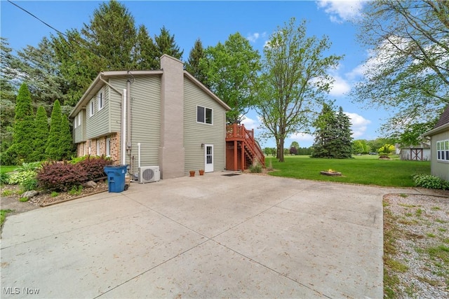 9113 Dean Rd, Vermilion, OH 44089 - view of home's exterior featuring stairway, a patio, a yard, ac unit, and a wooden deck