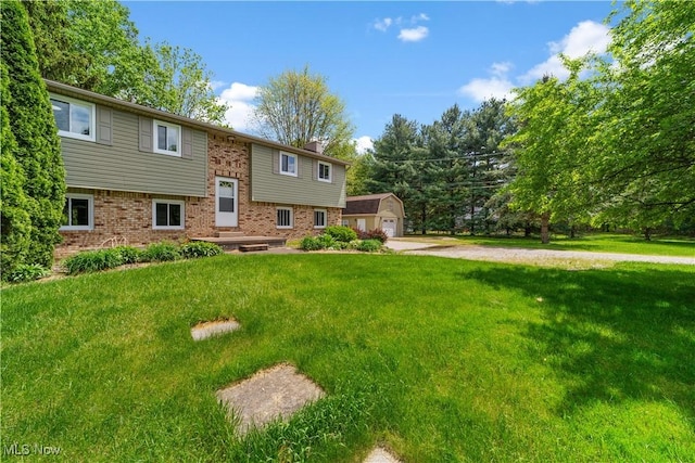 9113 Dean Rd, Vermilion, OH 44089 - raised ranch with brick siding, a front lawn, a chimney, and an outbuilding