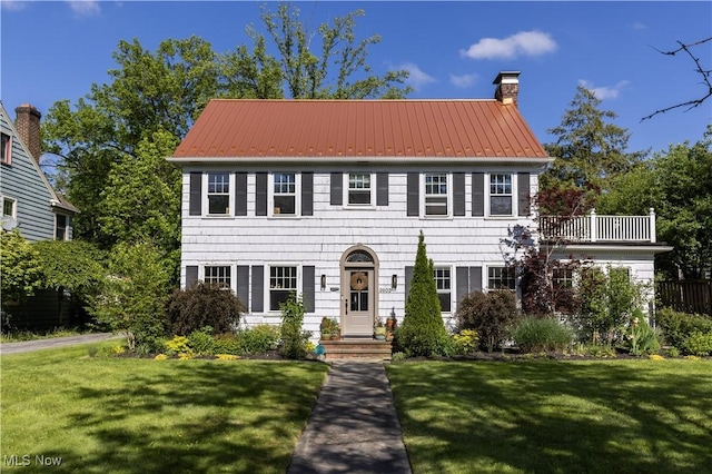 2671 Haddam Rd, Cleveland, OH 44120 - colonial-style house featuring a chimney, a front lawn, and metal roof