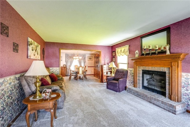 961 Prescot Ave NW, Massillon, OH 44646 - carpeted living room with a chandelier, a brick fireplace, and wallpapered walls
