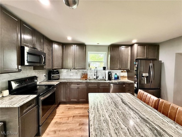 7509 S Palmyra Rd, Canfield, OH 44406 - kitchen with stainless steel appliances, a sink, decorative backsplash, dark brown cabinets, and recessed lighting
