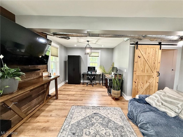7509 S Palmyra Rd, Canfield, OH 44406 - living area featuring light wood-type flooring, a barn door, and baseboards