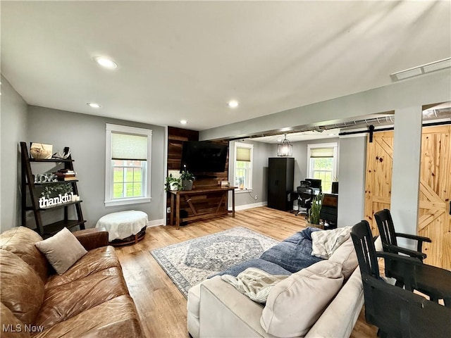 7509 S Palmyra Rd, Canfield, OH 44406 - living room featuring light wood-type flooring, a barn door, recessed lighting, and baseboards