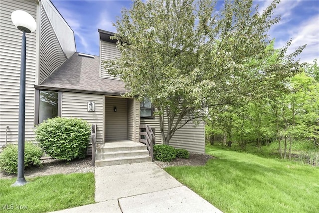 1145 Canyon View Rd Unit 206, Sagamore Hills, OH 44067 - view of front facade with roof with shingles and a front lawn