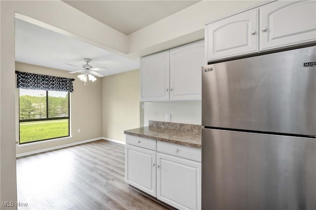 1145 Canyon View Rd Unit 206, Sagamore Hills, OH 44067 - kitchen featuring freestanding refrigerator, white cabinetry, ceiling fan, light wood-style floors, and baseboards