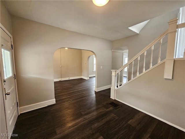 3891 W 21st St, Cleveland, OH 44109 - foyer entrance featuring arched walkways, baseboards, wood finished floors, and plenty of natural light