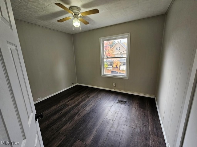 3891 W 21st St, Cleveland, OH 44109 - spare room with dark wood finished floors, a ceiling fan, and baseboards