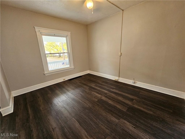 3891 W 21st St, Cleveland, OH 44109 - spare room featuring dark wood-type flooring, baseboards, and a ceiling fan