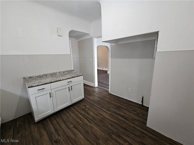 3891 W 21st St, Cleveland, OH 44109 - kitchen with arched walkways, dark wood-type flooring, and white cabinetry