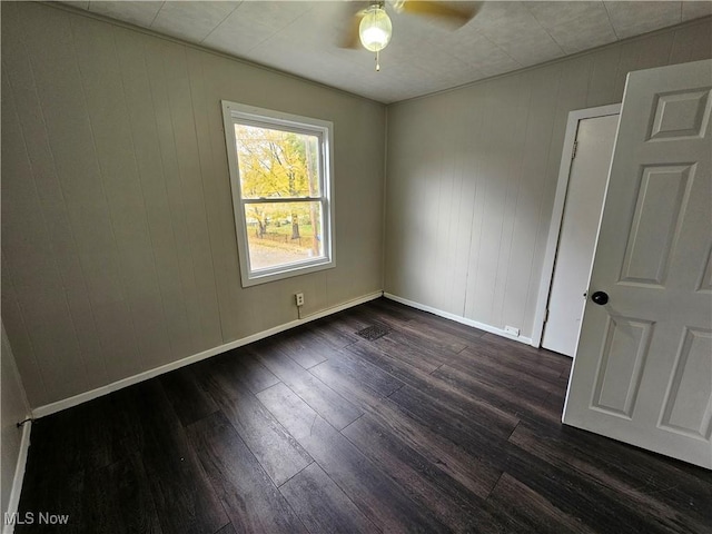 3891 W 21st St, Cleveland, OH 44109 - empty room with ceiling fan, dark wood finished floors, and baseboards