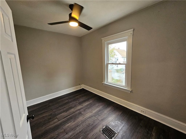 3891 W 21st St, Cleveland, OH 44109 - spare room featuring dark wood-type flooring, baseboards, and ceiling fan