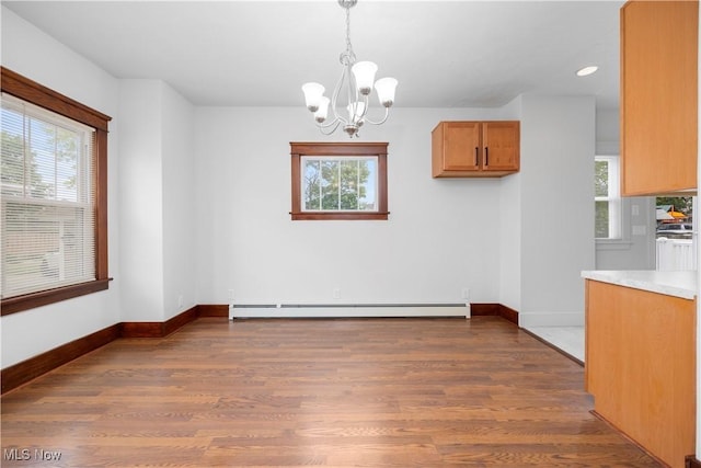 1138 W 6th St, Lorain, OH 44052 - unfurnished dining area featuring a baseboard heating unit, a chandelier, dark wood finished floors, healthy amount of natural light, and recessed lighting