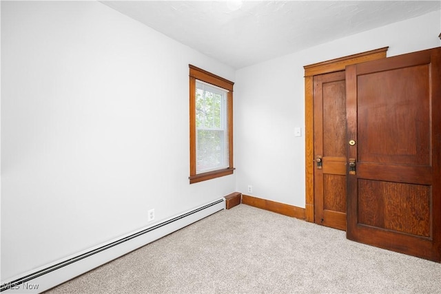 1138 W 6th St, Lorain, OH 44052 - carpeted empty room with a baseboard heating unit and baseboards