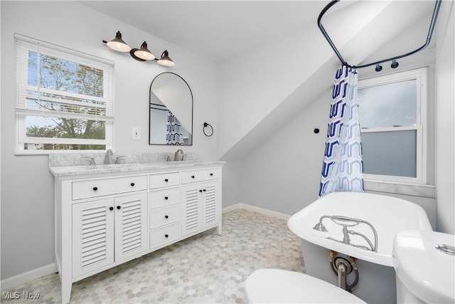 1138 W 6th St, Lorain, OH 44052 - bathroom featuring toilet, baseboards, a soaking tub, a shower with curtain, and tile patterned floors
