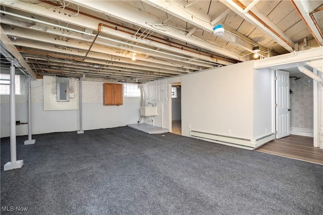 1138 W 6th St, Lorain, OH 44052 - basement featuring a baseboard heating unit, a sink, and electric panel