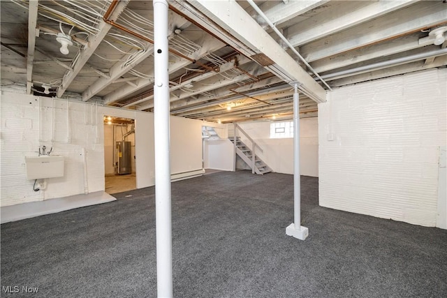 1138 W 6th St, Lorain, OH 44052 - basement with water heater, a sink, stairs, and carpet flooring