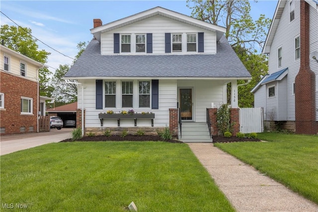 1138 W 6th St, Lorain, OH 44052 - bungalow with a shingled roof, a front yard, and a chimney