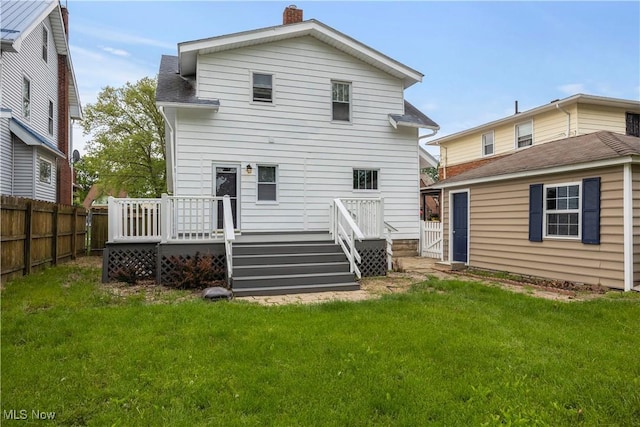 1138 W 6th St, Lorain, OH 44052 - rear view of property with a chimney and a deck