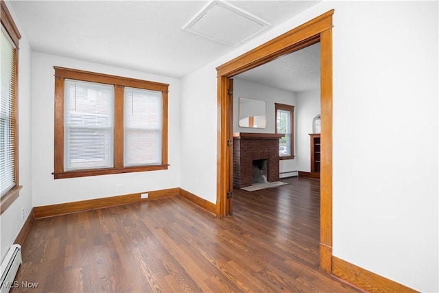 1138 W 6th St, Lorain, OH 44052 - empty room featuring a baseboard radiator, baseboards, dark wood-style floors, a fireplace, and a baseboard heating unit
