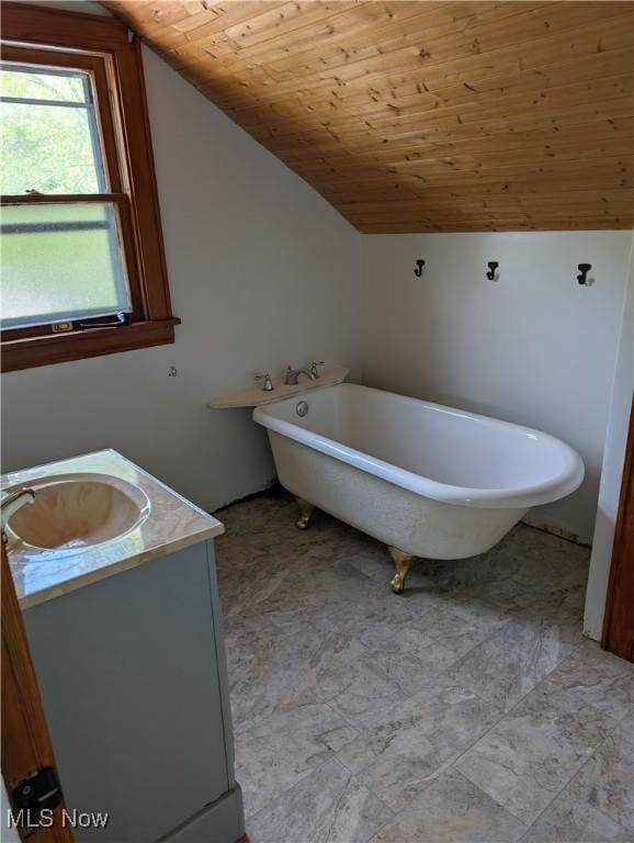630 N Lincoln Ct, Louisville, OH 44641 - full bath featuring vaulted ceiling, vanity, a freestanding tub, and wooden ceiling