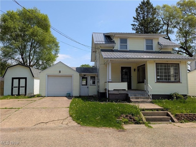 630 N Lincoln Ct, Louisville, OH 44641 - view of front of home featuring covered porch, concrete driveway, an attached garage, a metal roof, and a storage unit