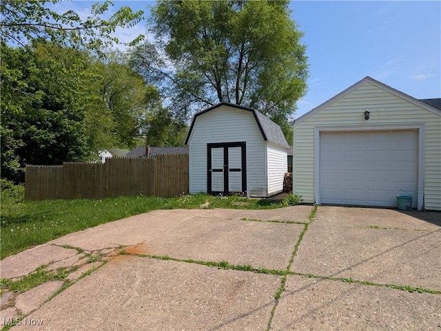 630 N Lincoln Ct, Louisville, OH 44641 - detached garage featuring concrete driveway and a storage shed