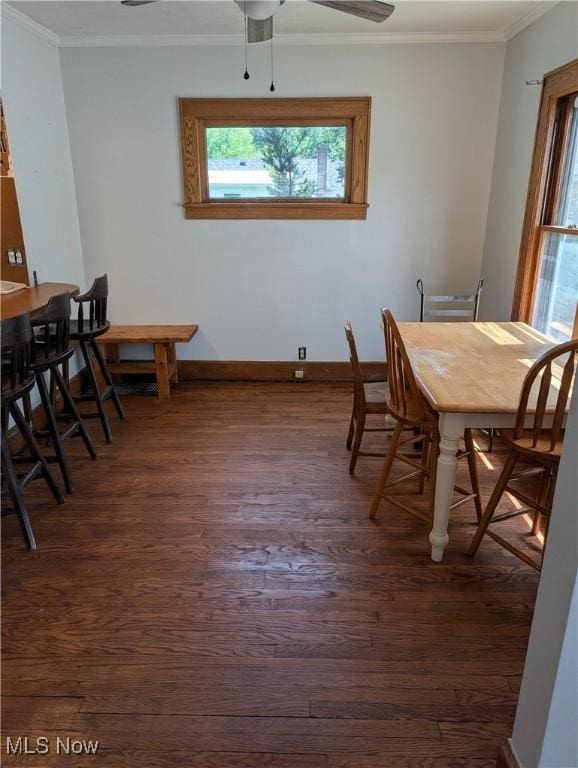 630 N Lincoln Ct, Louisville, OH 44641 - dining room with healthy amount of natural light, dark wood finished floors, crown molding, and ceiling fan
