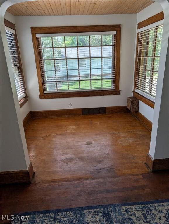 630 N Lincoln Ct, Louisville, OH 44641 - unfurnished room with arched walkways, wood finished floors, plenty of natural light, and wooden ceiling