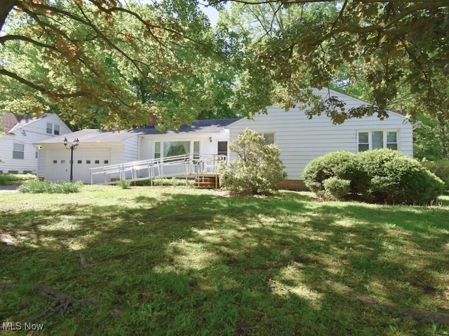 4628 Monticello Blvd, South Euclid, OH 44143 - rear view of house with a garage and a lawn