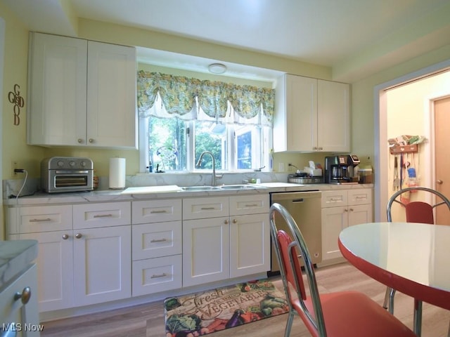 4628 Monticello Blvd, South Euclid, OH 44143 - kitchen featuring a sink, dishwasher, white cabinets, and light wood-type flooring