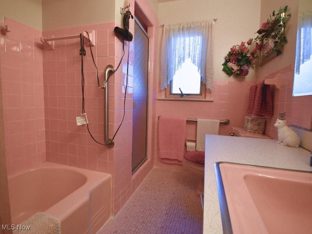 4628 Monticello Blvd, South Euclid, OH 44143 - bathroom featuring tile walls, plenty of natural light, toilet, vanity, and wainscoting