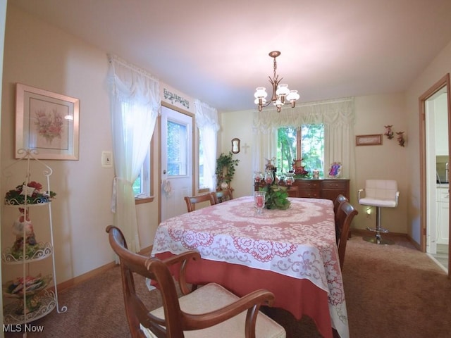 4628 Monticello Blvd, South Euclid, OH 44143 - carpeted dining space featuring a chandelier and baseboards