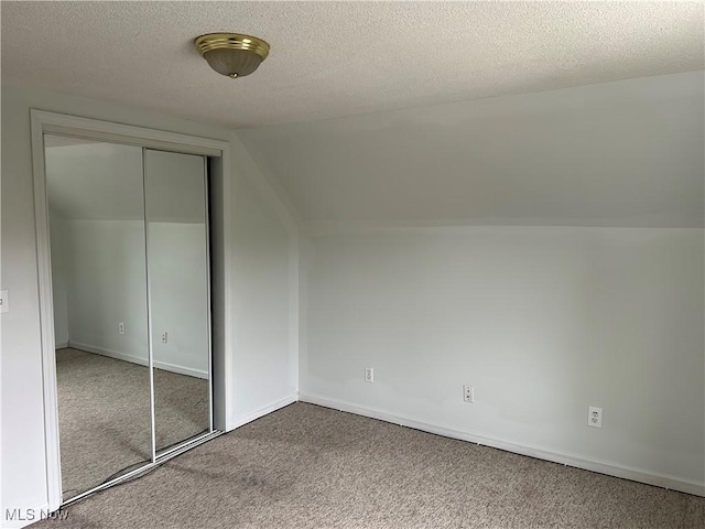 201 E St, Caldwell, OH 43724 - bonus room with carpet flooring, a textured ceiling, lofted ceiling, and baseboards