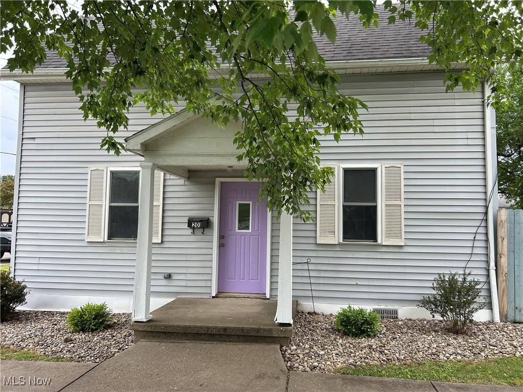 201 E St, Caldwell, OH 43724 - obstructed view of property featuring roof with shingles