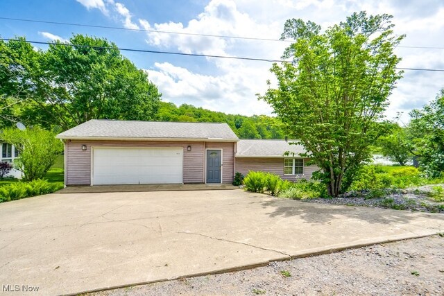 10311 Myers Rd, Kensington, OH 44427 - view of front facade with an outdoor structure, a detached garage, and roof with shingles