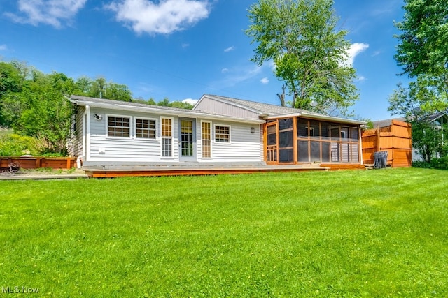 10311 Myers Rd, Kensington, OH 44427 - rear view of house featuring a sunroom, a lawn, and a deck