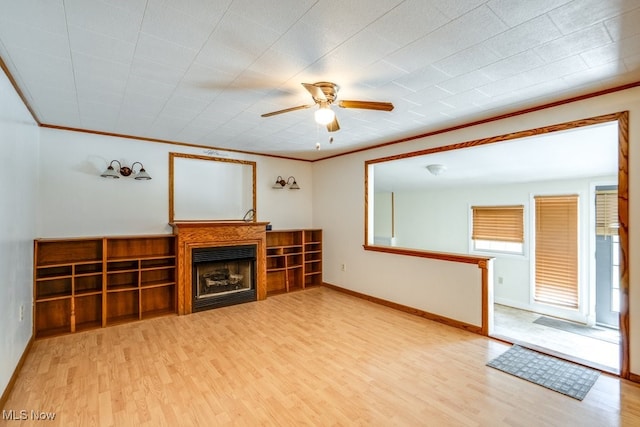 10311 Myers Rd, Kensington, OH 44427 - unfurnished living room featuring a ceiling fan, wood finished floors, a fireplace, baseboards, and crown molding