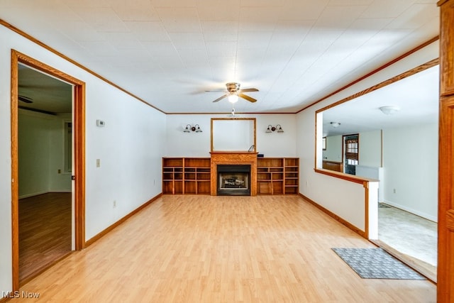 10311 Myers Rd, Kensington, OH 44427 - unfurnished living room featuring a ceiling fan, light wood-style flooring, a fireplace, ornamental molding, and baseboards