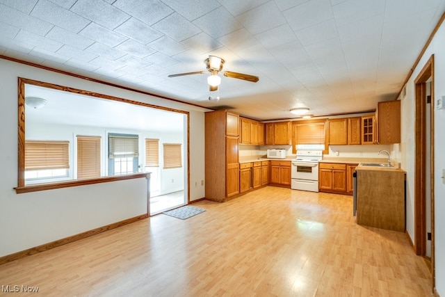 10311 Myers Rd, Kensington, OH 44427 - kitchen with white appliances, a sink, light wood-type flooring, ceiling fan, and brown cabinets