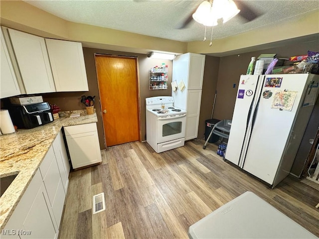 78 Findley St, Dillonvale, OH 43917 - kitchen featuring white appliances, light wood-style flooring, white cabinets, and a textured ceiling