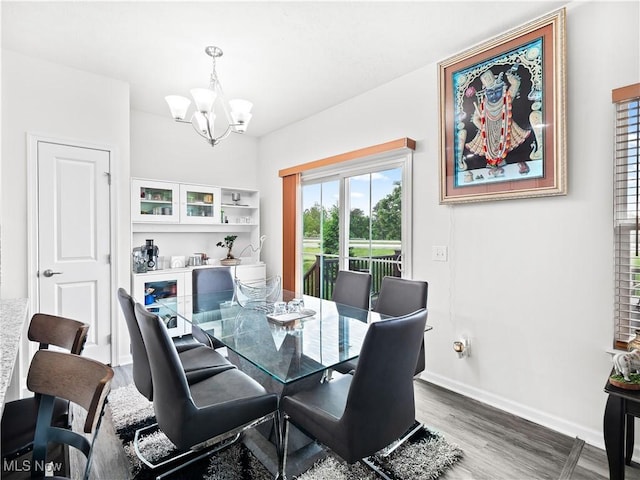 3243 Broadleaf Way, Brunswick, OH 44212 - dining area with a chandelier, wood finished floors, and baseboards