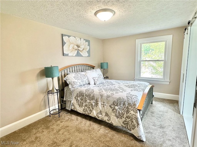 177 N Cleveland Ave, Mogadore, OH 44260 - bedroom with carpet, a textured ceiling, and a barn door