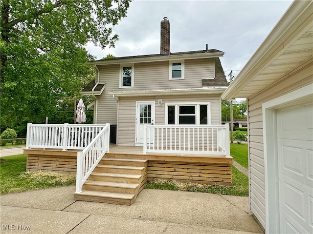 177 N Cleveland Ave, Mogadore, OH 44260 - rear view of property with a chimney, a deck, roof with shingles, and a garage