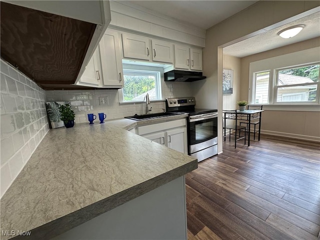 177 N Cleveland Ave, Mogadore, OH 44260 - kitchen featuring stainless steel range with electric cooktop, under cabinet range hood, white cabinets, tasteful backsplash, and dark wood-style flooring