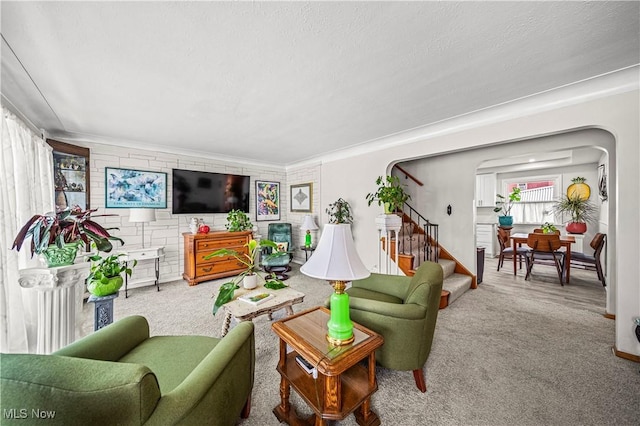 131 E 206th St, Euclid, OH 44123 - living room with carpet flooring, stairs, crown molding, and arched walkways