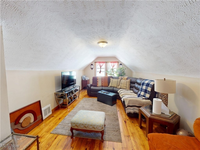 3882 Wallingford Rd, South Euclid, OH 44121 - living room with a textured ceiling, hardwood / wood-style flooring, vaulted ceiling, and baseboards