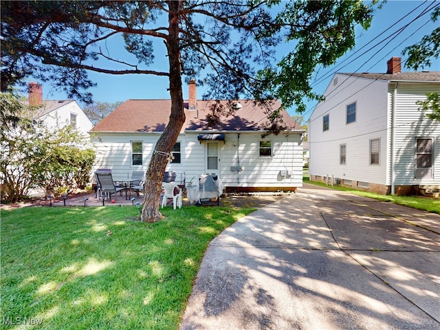 3882 Wallingford Rd, South Euclid, OH 44121 - back of property featuring a yard, a patio, and a chimney